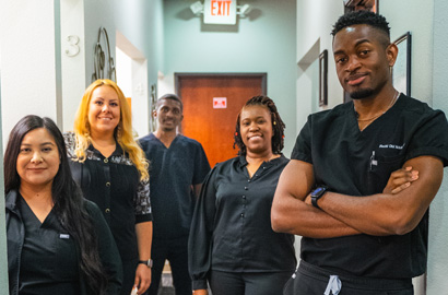 Euless team in hallway at Ideal Dental Euless